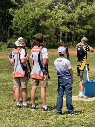 Youth clay target shooting team competing at a high school event